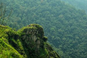 "Breathtaking sunrise over the Western Ghats in Kerala, with mist-covered hills and vibrant skies."