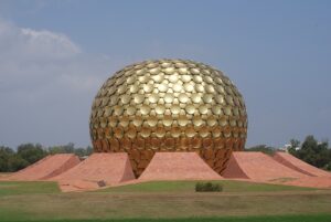 "Golden sphere of the Matrimandir in Auroville, near Pondicherry, with its unique, reflective discs shining under the sun."